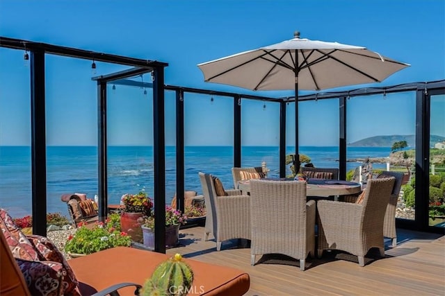 wooden terrace featuring a water view