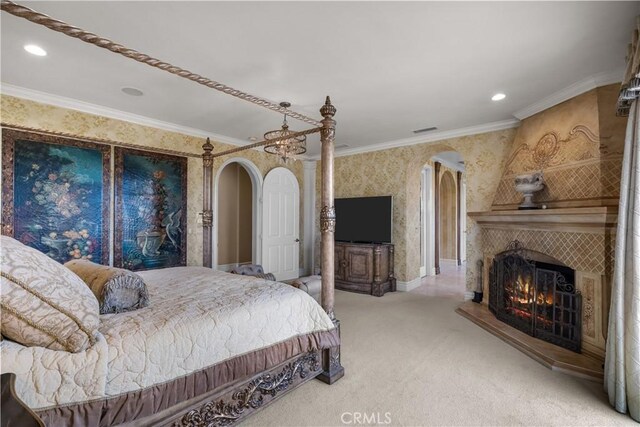 bedroom with carpet, crown molding, and a fireplace