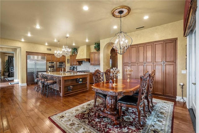 dining area with dark hardwood / wood-style floors and sink