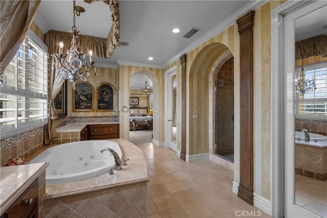 bathroom with an inviting chandelier, vanity, crown molding, and shower with separate bathtub