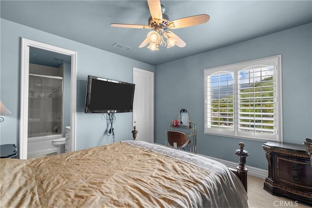 carpeted bedroom featuring ceiling fan and connected bathroom