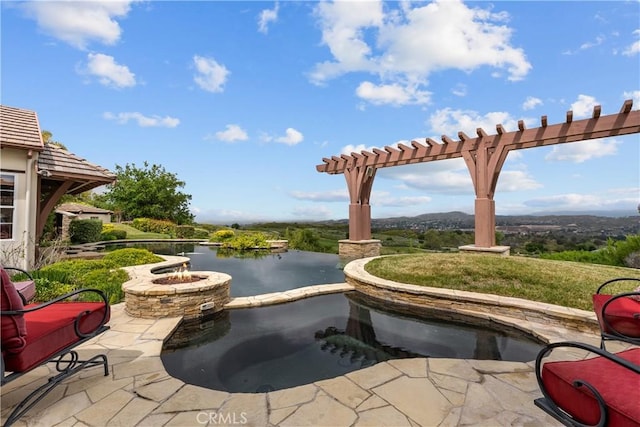 view of patio with a water view and a fire pit