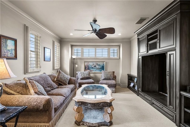 carpeted living room featuring ceiling fan and crown molding