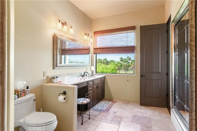 bathroom featuring vanity, toilet, and walk in shower