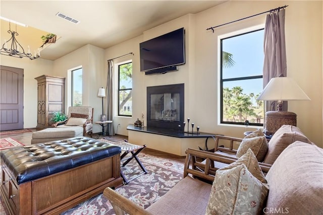 living room with hardwood / wood-style floors and a notable chandelier