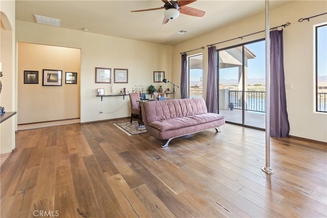 interior space with ceiling fan and wood-type flooring