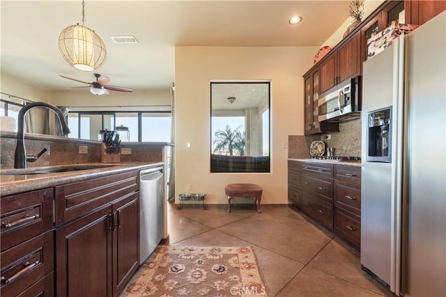 kitchen with ceiling fan, sink, hanging light fixtures, tile patterned flooring, and appliances with stainless steel finishes