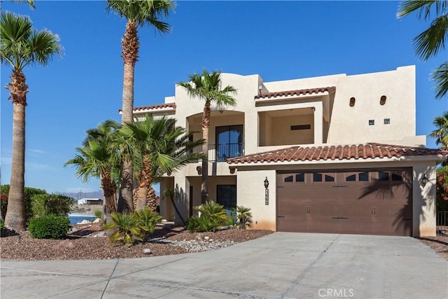 view of front of property featuring a balcony and a garage