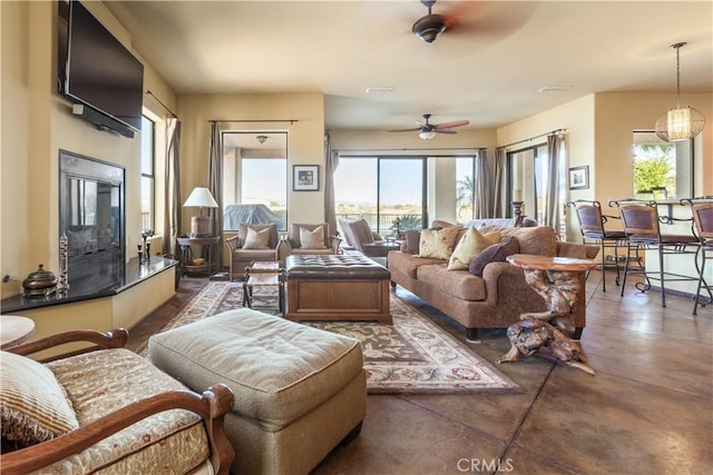 living room featuring plenty of natural light and ceiling fan