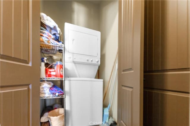 laundry area with stacked washer / dryer