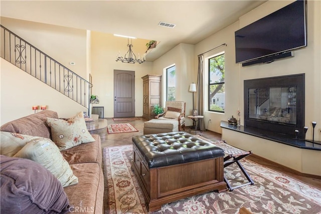 tiled living room featuring a notable chandelier