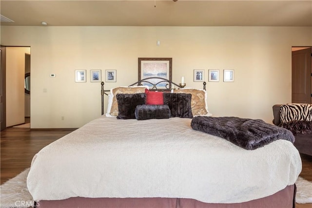 bedroom with dark hardwood / wood-style flooring