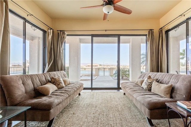 living room featuring a water view and ceiling fan