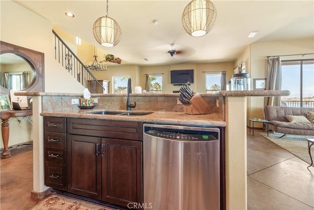 kitchen with dishwasher, sink, light tile patterned floors, decorative light fixtures, and dark brown cabinetry