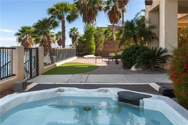 view of pool with a patio and an outdoor hot tub