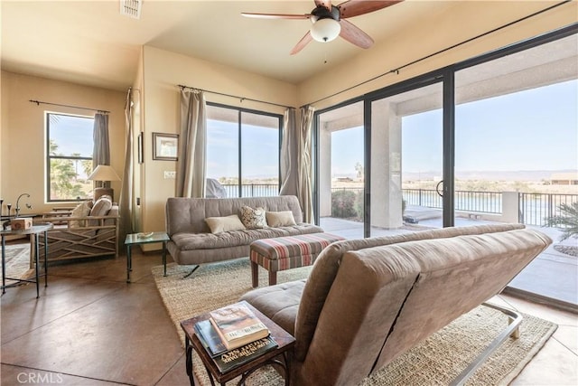 interior space featuring a water view, a wealth of natural light, and ceiling fan