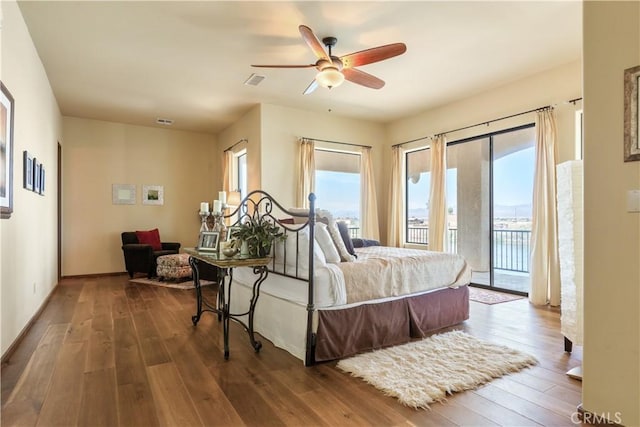 bedroom featuring ceiling fan, dark hardwood / wood-style flooring, and access to outside