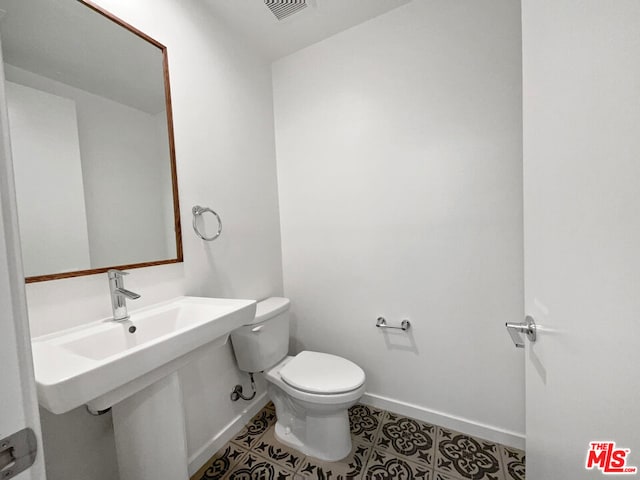 bathroom featuring tile patterned floors and toilet