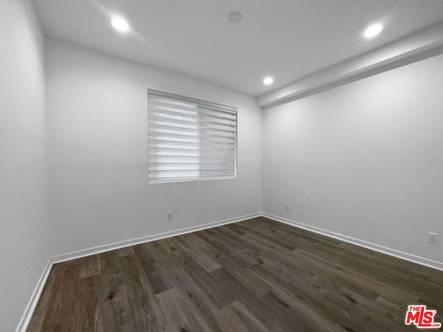 empty room with dark hardwood / wood-style floors