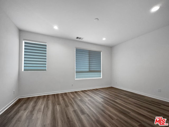 empty room with dark wood-type flooring