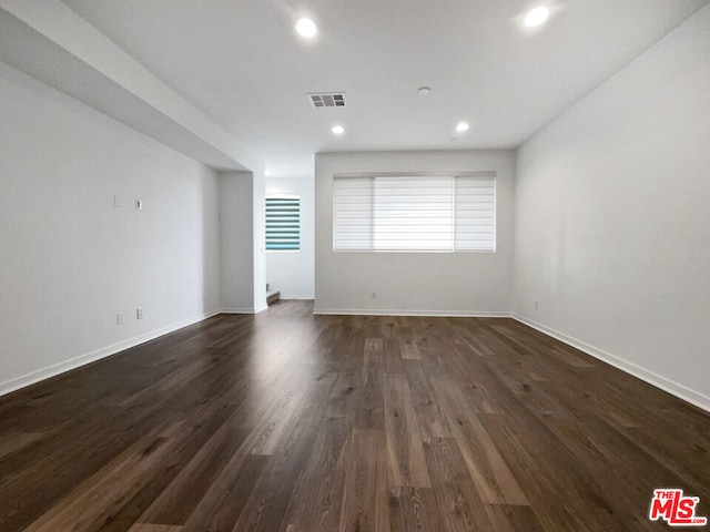 empty room with dark hardwood / wood-style floors