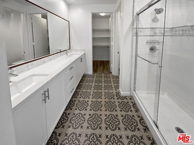 bathroom with vanity and a shower with shower door