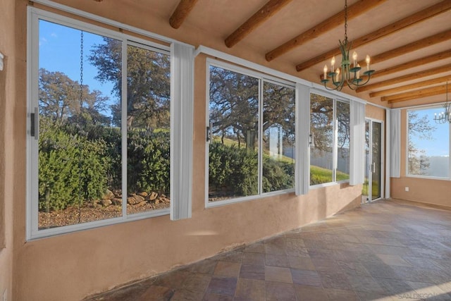 unfurnished sunroom with an inviting chandelier and beam ceiling