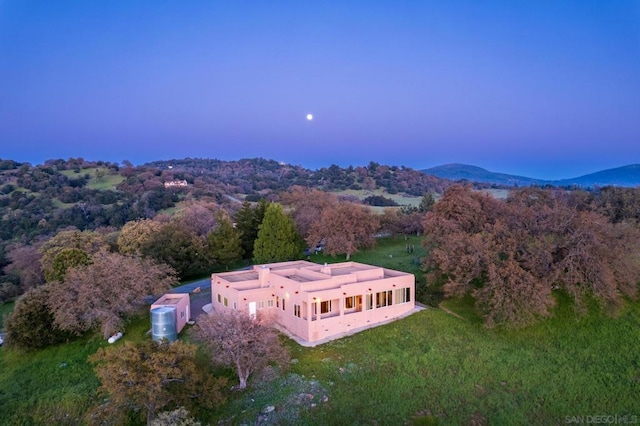 aerial view at dusk featuring a mountain view