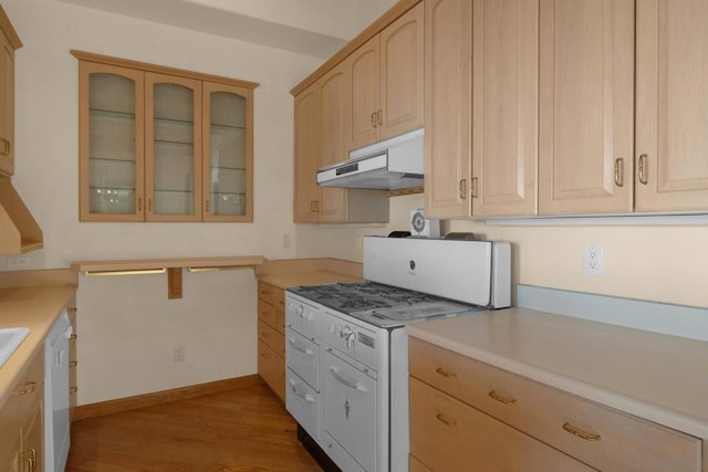 kitchen with white appliances, light brown cabinetry, and hardwood / wood-style floors