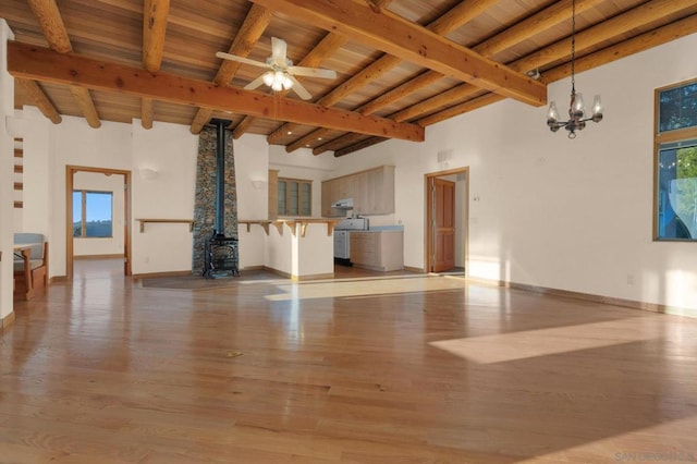 unfurnished living room with hardwood / wood-style floors, ceiling fan with notable chandelier, beam ceiling, and wooden ceiling