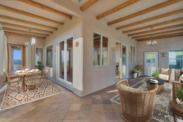 interior space featuring an inviting chandelier and beam ceiling