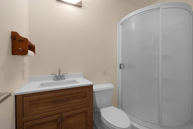 bathroom with vanity, toilet, and walk in shower