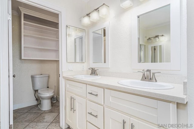 bathroom with tile patterned flooring, vanity, and toilet