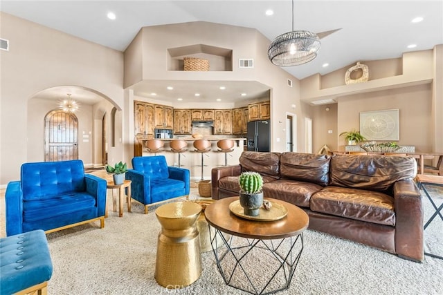 living room featuring light carpet and high vaulted ceiling