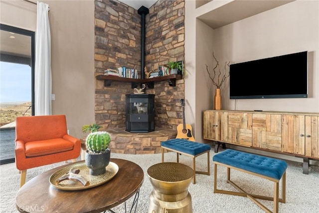 living room with carpet flooring and a wood stove