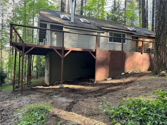 back of house featuring a wooden deck