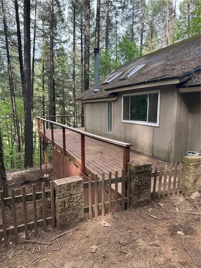 view of property exterior with a wooden deck