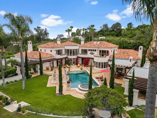 rear view of property featuring a patio and a yard