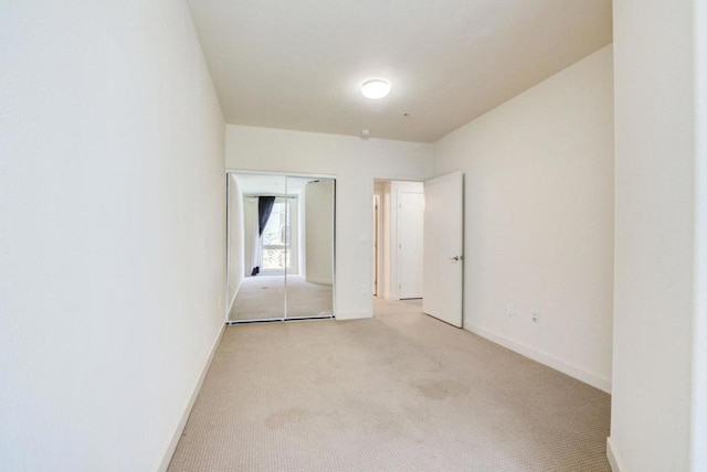 unfurnished bedroom with light colored carpet