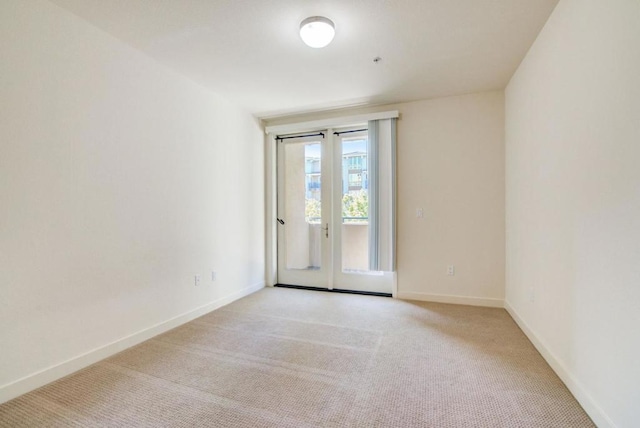 carpeted empty room with french doors