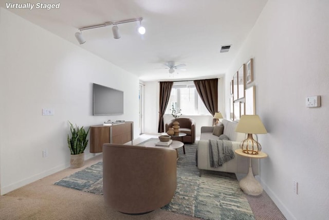 living room with carpet, track lighting, and ceiling fan