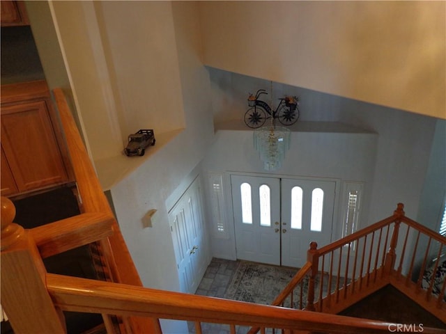 foyer entrance with french doors and a chandelier