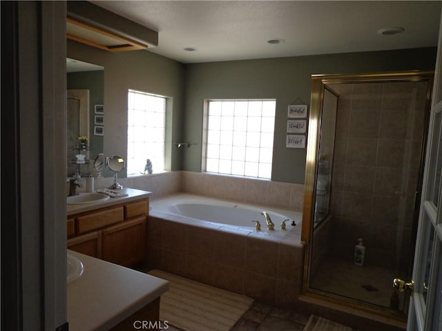 bathroom featuring vanity and separate shower and tub