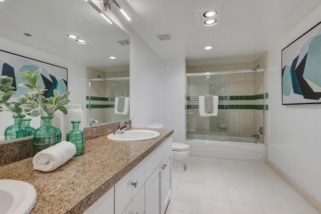 full bathroom featuring toilet, vanity, and enclosed tub / shower combo