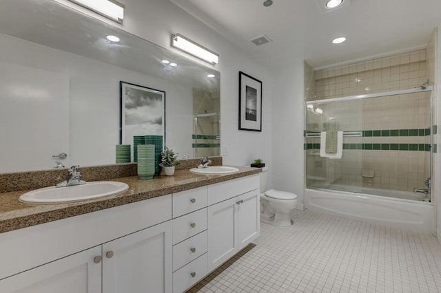 full bathroom with toilet, tile patterned floors, enclosed tub / shower combo, and vanity