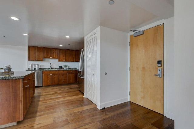 kitchen featuring hardwood / wood-style flooring, sink, and appliances with stainless steel finishes