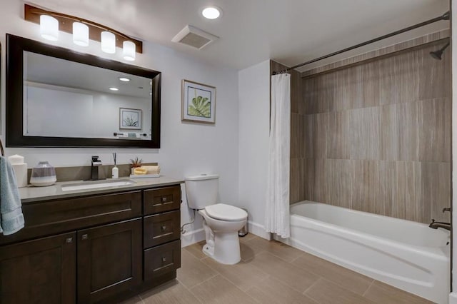 full bathroom featuring shower / bath combo with shower curtain, tile patterned floors, toilet, and vanity