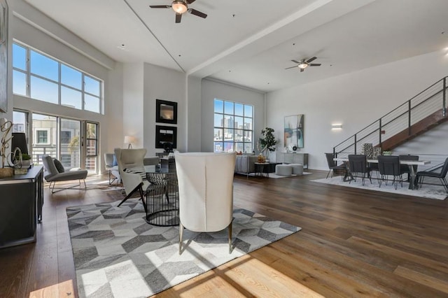 living room featuring ceiling fan and dark hardwood / wood-style floors