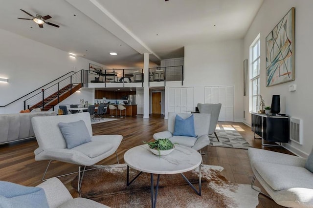 living room featuring ceiling fan and hardwood / wood-style flooring