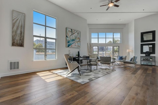 sitting room with hardwood / wood-style flooring and ceiling fan